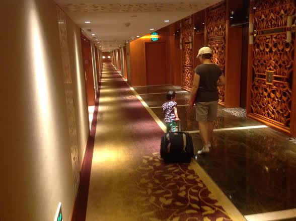 Mei Li is practicing pulling her luggage in case dad needs help! ;)